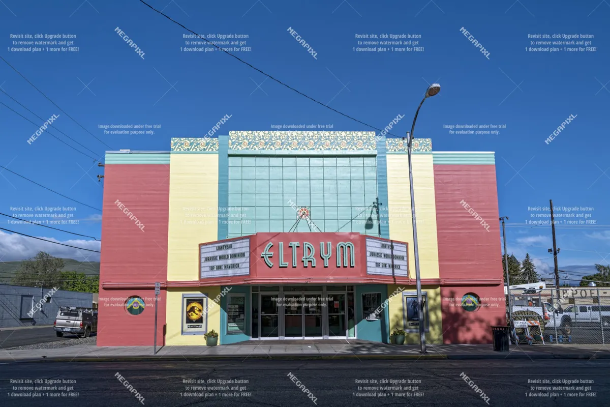 The exterior of the historic Eltrym Theater, featuring a vibrant facade, a prominent marquee with the theater’s name, and decorative roof trim. The scene evokes the lively atmosphere of Baker City’s downtown and its cultural offerings.