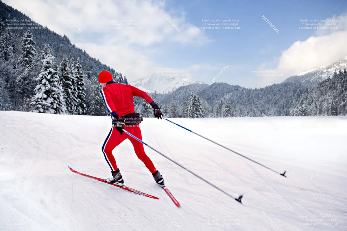 A skier glides through a pristine snowy landscape with mountains and evergreen trees in the background, capturing the thrill and beauty of a winter sports adventure.